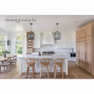 A kitchen island with a dining room to one side.