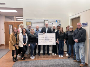Group of people with an oversized check for Project Help.